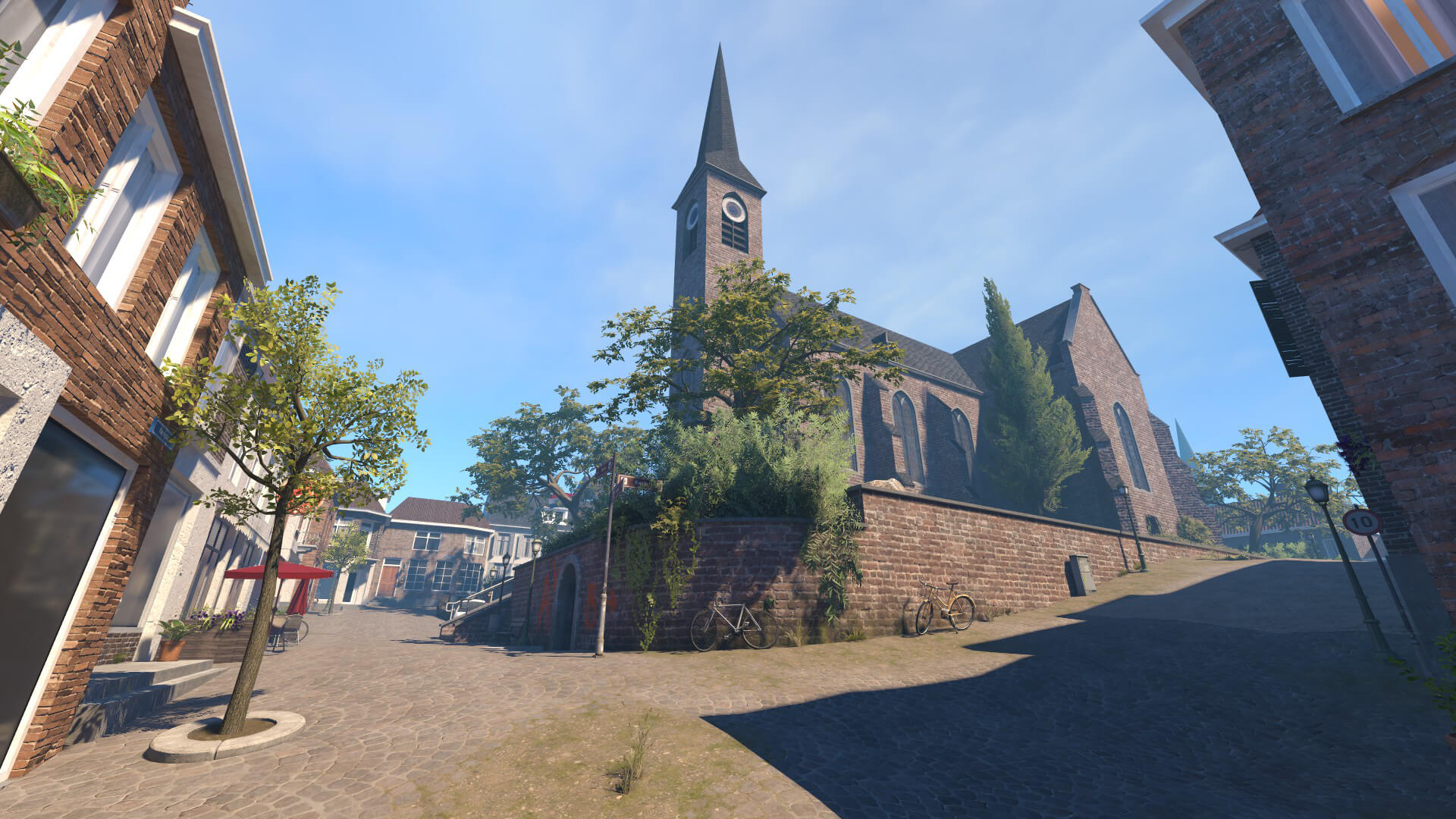 Market square at mid with a church, shops and bicycles in the Counter-Strike 2 map VESPER