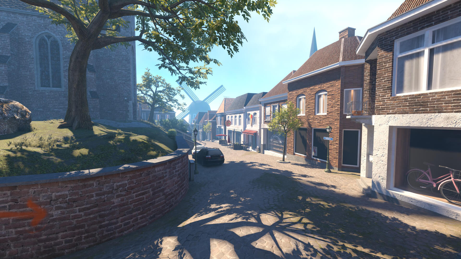 Church square with views of the shops and a moving windmill in the Counter-Strike 2 map VESPER